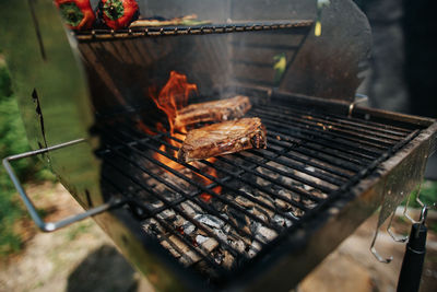 Two iberico chops on a grill with high flame