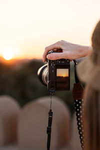Close-up of man photographing with camera