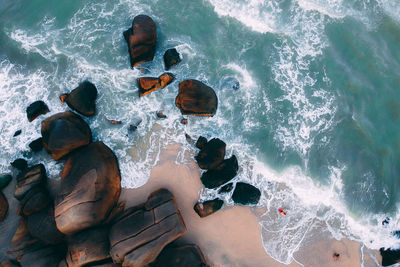 High angle view of rocks in sea