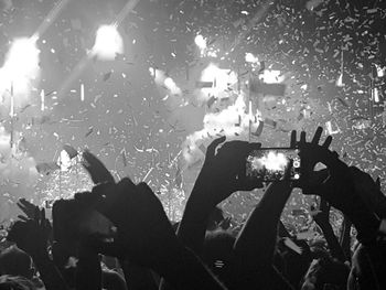 People photographing music concert at night