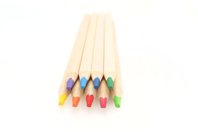 Close-up of multi colored pencils against white background