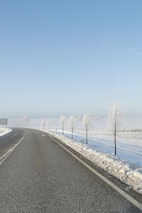 Road against clear sky during winter