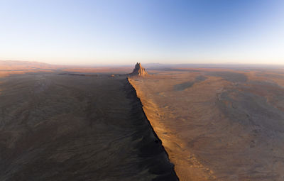 Aerial with leading line of lava towards shiprock in new mexico