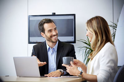 Woman using mobile phone in office