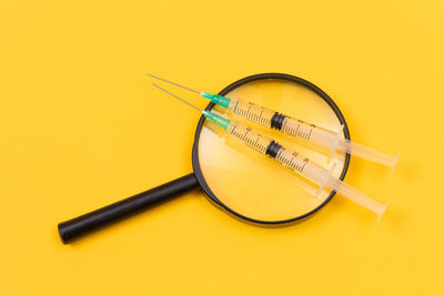 High angle view of wheel against yellow background