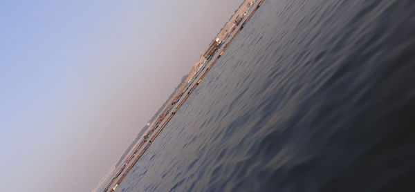 Low angle view of sea against sky at sunset