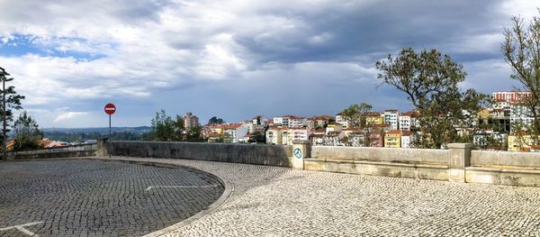 Street amidst buildings in town against sky