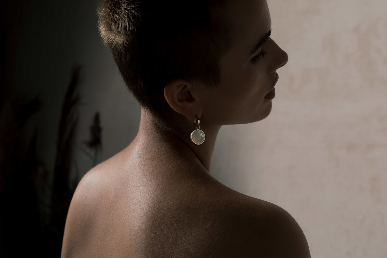 one person, headshot, portrait, adult, close-up, women, indoors, black, human face, profile view, rear view, fashion, young adult, looking, hairstyle, studio shot, jewelry, back, female, hair bun, human hair, human head, contemplation, child, bride, brown hair, dress, person, looking away