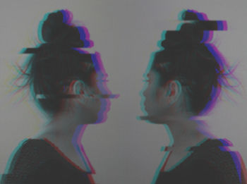 Multiple exposure of woman against gray background