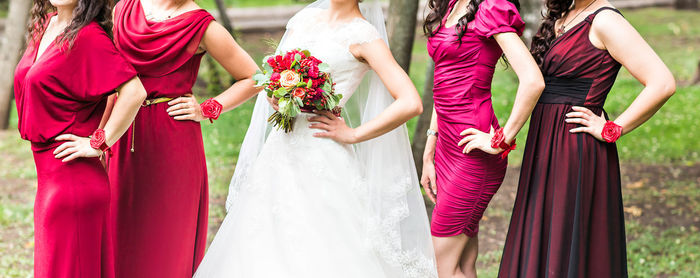 Midsection of bride holding bouquet