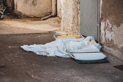 Garbage can against wall