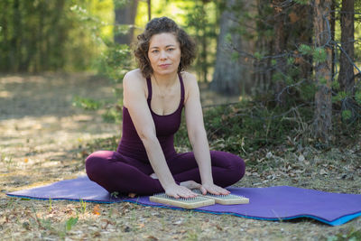 Young woman sitting on field