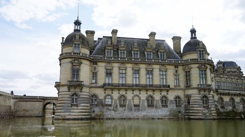 Low angle view of building against cloudy sky