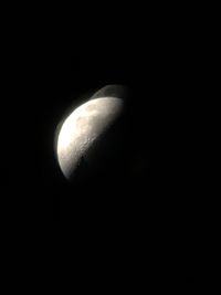 Low angle view of half moon against sky at night