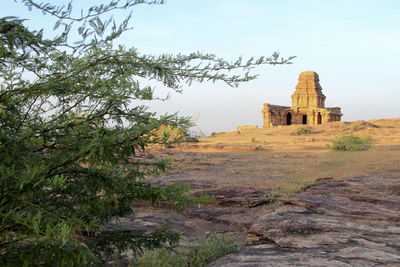 Historic building on field against sky