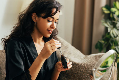 Young woman looking away at home