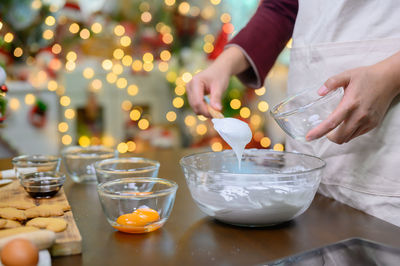 Midsection of man preparing food on table