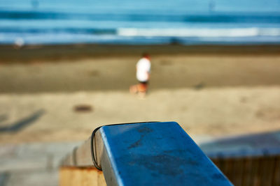 Rear view of man running on beach