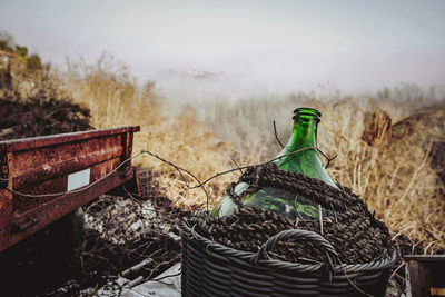 Abandoned rusty cart and jug in winter