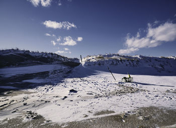 Scenic view of snowcapped beach against sky