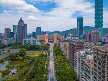 Aerial view of buildings in city against sky