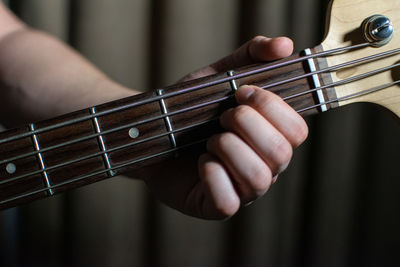 Close-up of hands playing guitar