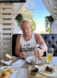Portrait of young woman having food at home