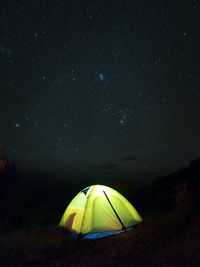 Illuminated tent against sky at night