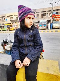 Portrait of young woman standing on street