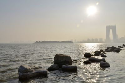 City skyline and oriental arc next to the sea. suzhou, china.