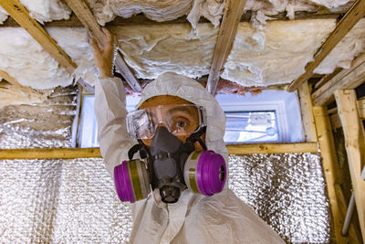 Portrait of man working on ceiling
