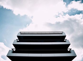 Low angle view of building against cloudy sky