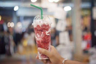 Close-up of hand holding glass of drink