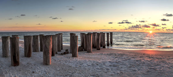 Dilapidated ruins of a pier on port royal beach at sunset in naples, florida