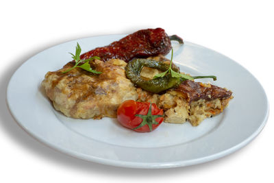 Close-up of food in plate against white background