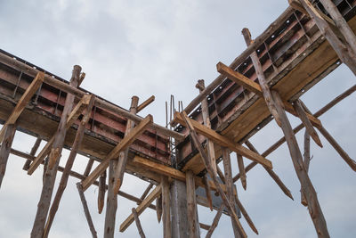 Low angle view of wooden structure against sky