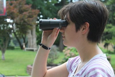 Close-up of boy photographing with camera