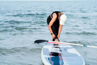 Woman surfing in sea