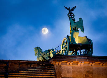 Low angle view of statue against blue sky