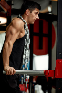 Side view of woman exercising in gym