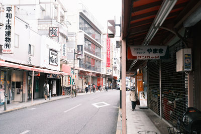 Road amidst buildings in city