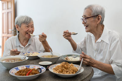 People eating food on table