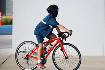 Side view of man riding bicycle