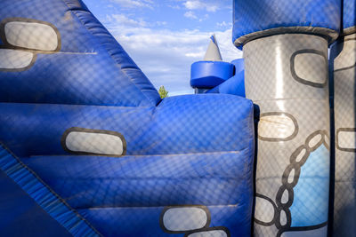 Close-up of stack of food on metal against blue sky