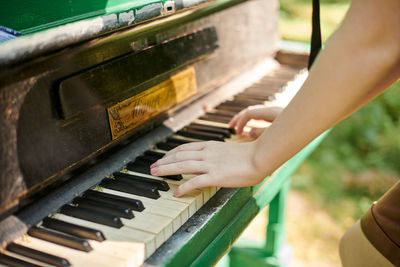 Midsection of woman playing piano