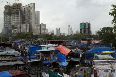 Panoramic view of buildings in city against sky