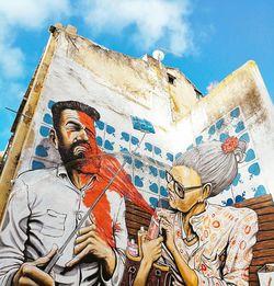 Low angle view of statues on building against sky