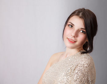 Portrait of a smiling young woman against white background