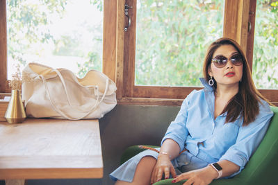 Portrait of woman sitting on at table in coffee shop