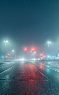 Illuminated road at night in fog